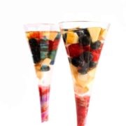 A close up of two tall glasses with Sangria