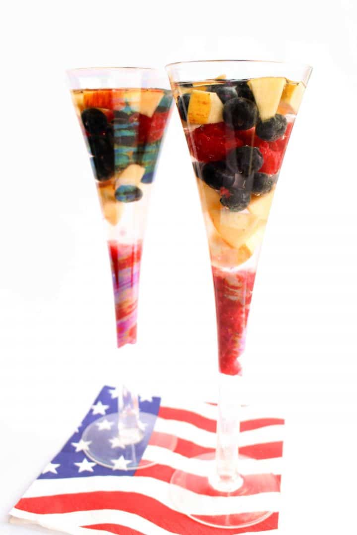 White Sangria in two tall glasses on an American flag napkin.