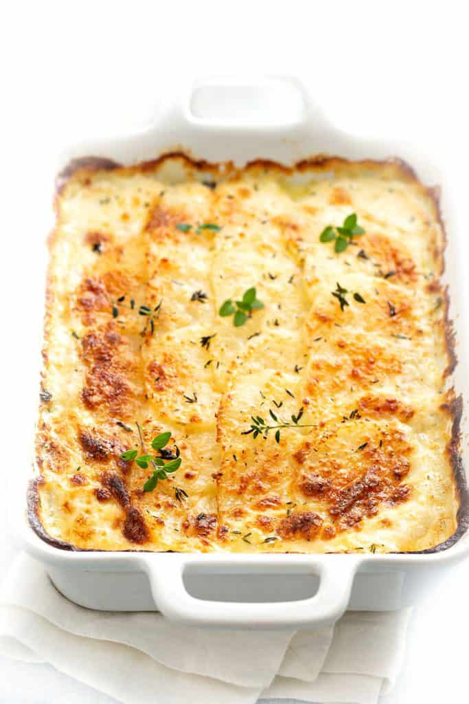 a dish of cheesy scalloped potatoes ready to serve.