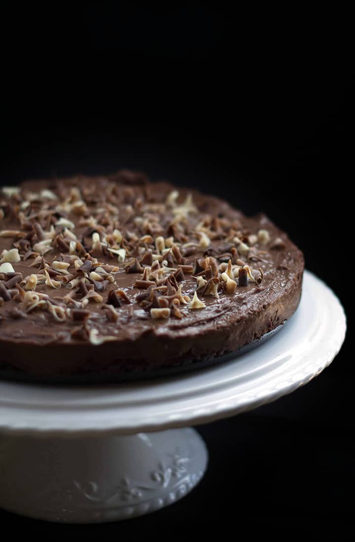 The Rich & Creamy No Bake Chocolate Torte on a white cake stand ready to serve