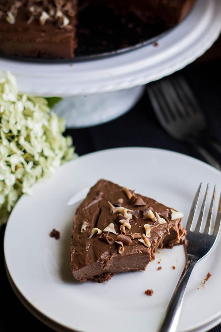 a piece of the torte on a plate with a fork with a bite missing from it