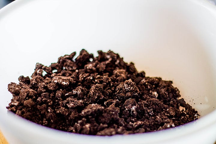 The cookie crumbs in a mixing bowl