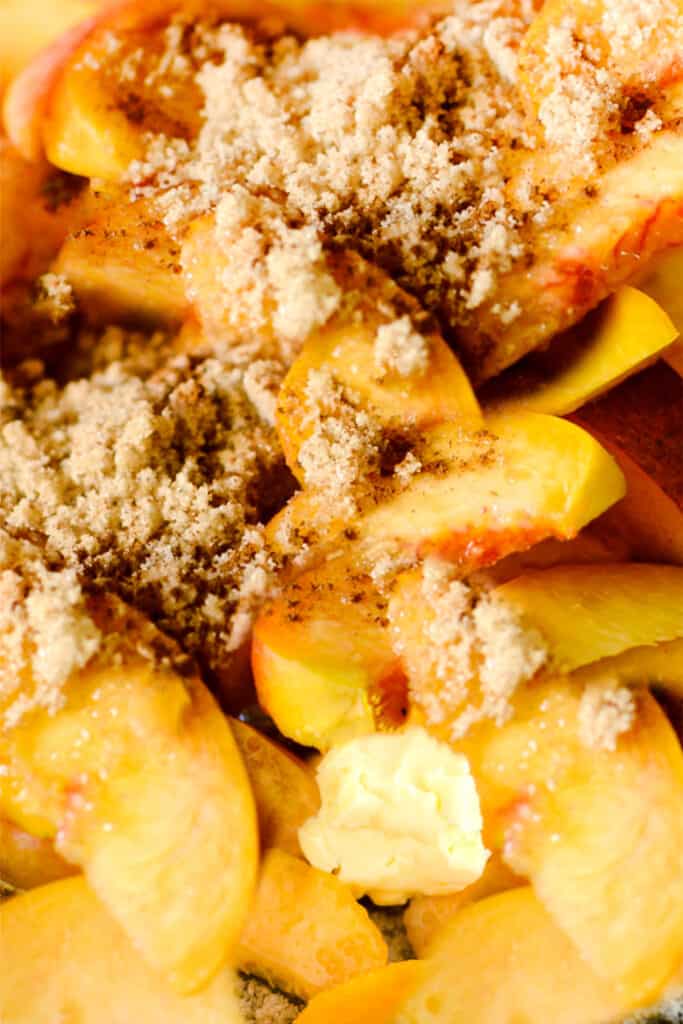 peaches in a pan with sugar and butter