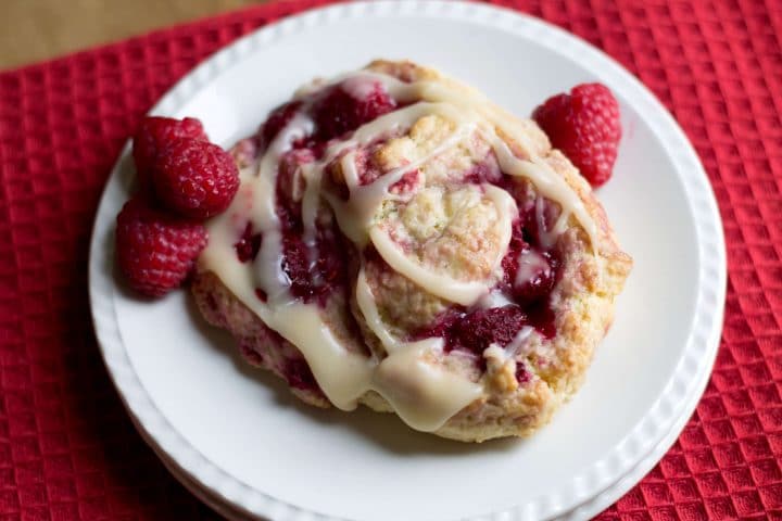 An Iced Raspberry Scone on a plate ready to eat