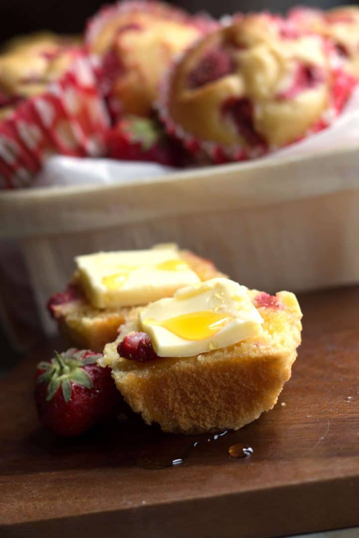 a strawberry honey cornbread muffin with butter and a drizzle of honey.