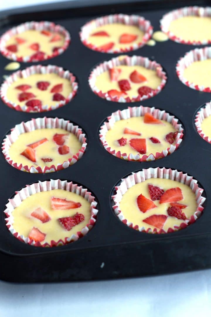 the strawberry honey cornbread batter in the muffin liners with the chopped strawberries added.