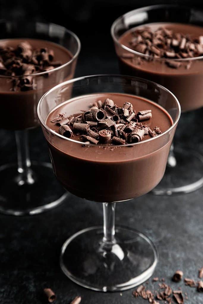 three pots de creme with shaved chocolate to decorate
