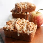 Apple crumb cakes ready to eat with an apple in the background