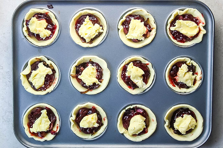 Brie cheese added to each tart with the cranberry and red onion
