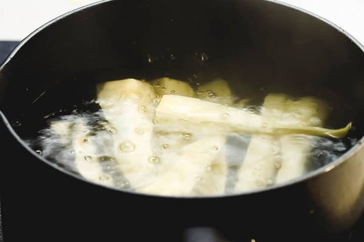 Parsnips boiling in a pot of water