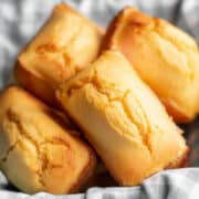 a pile of sweet cornbread loaves in a basket