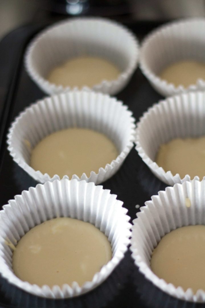 muffin batter in cake cases in a cake tin ready to bake