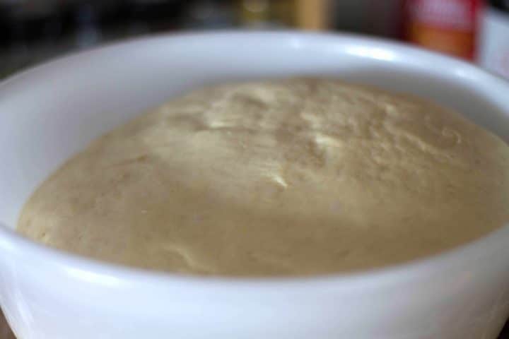 Quick rise dough in a plastic bowl