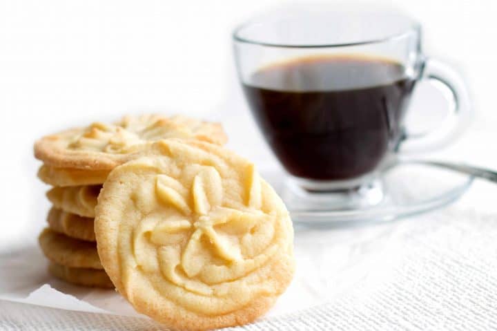 A cup of coffee on a table, with Cookie and Shortbread