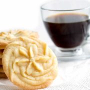 A cup of coffee on a table, with Cookie and Shortbread