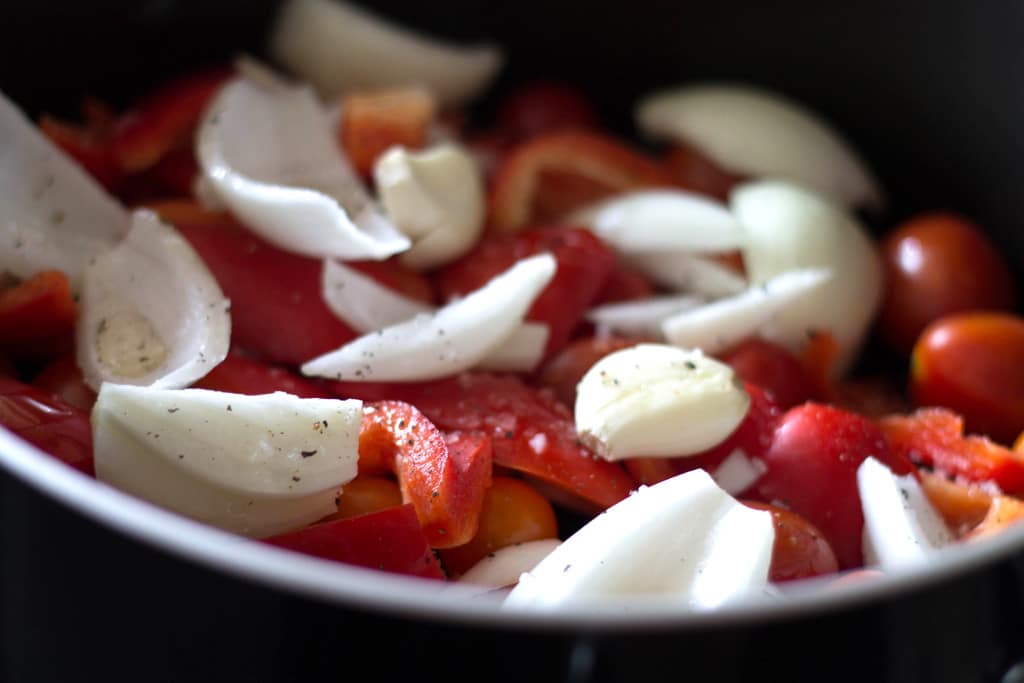 vegetables covered in olive oil ready to roast