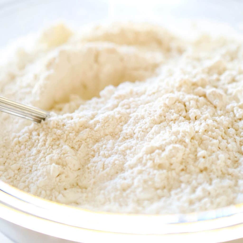 The flour in a glass mixing bowl