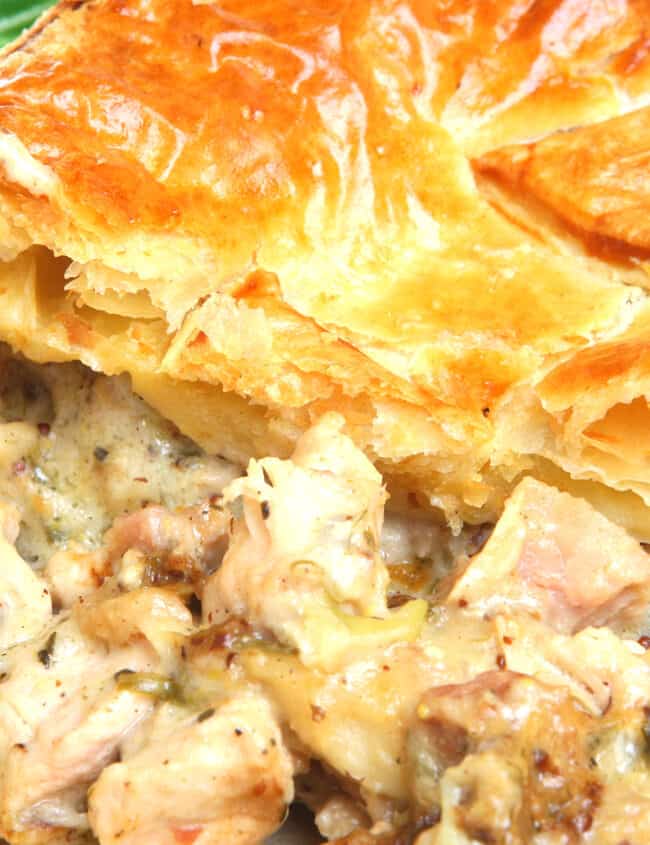 a close up of a chicken pie with a portion missing