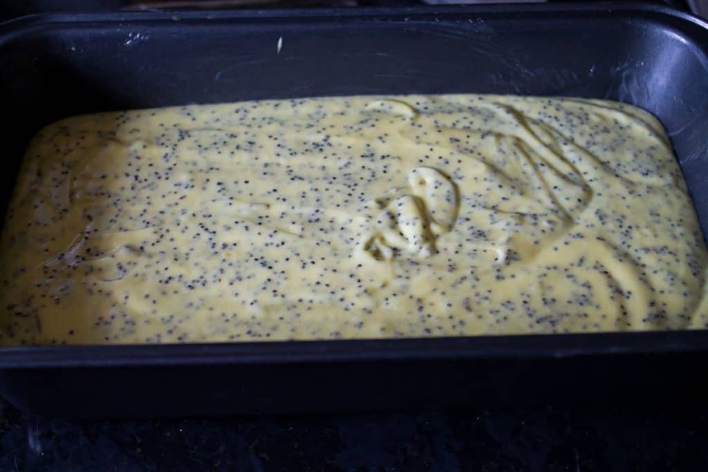 Lemon Poppyseed Drizzle Cake batter in a loaf pan