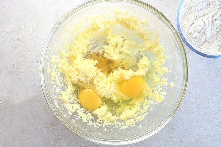 eggs added to the butter mixture in a mixing bowl