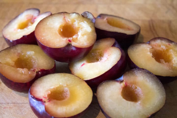 plums cut in half with the stones removed