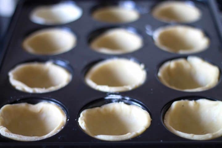 the pastry pressed into the cupcake pan ready to be filled