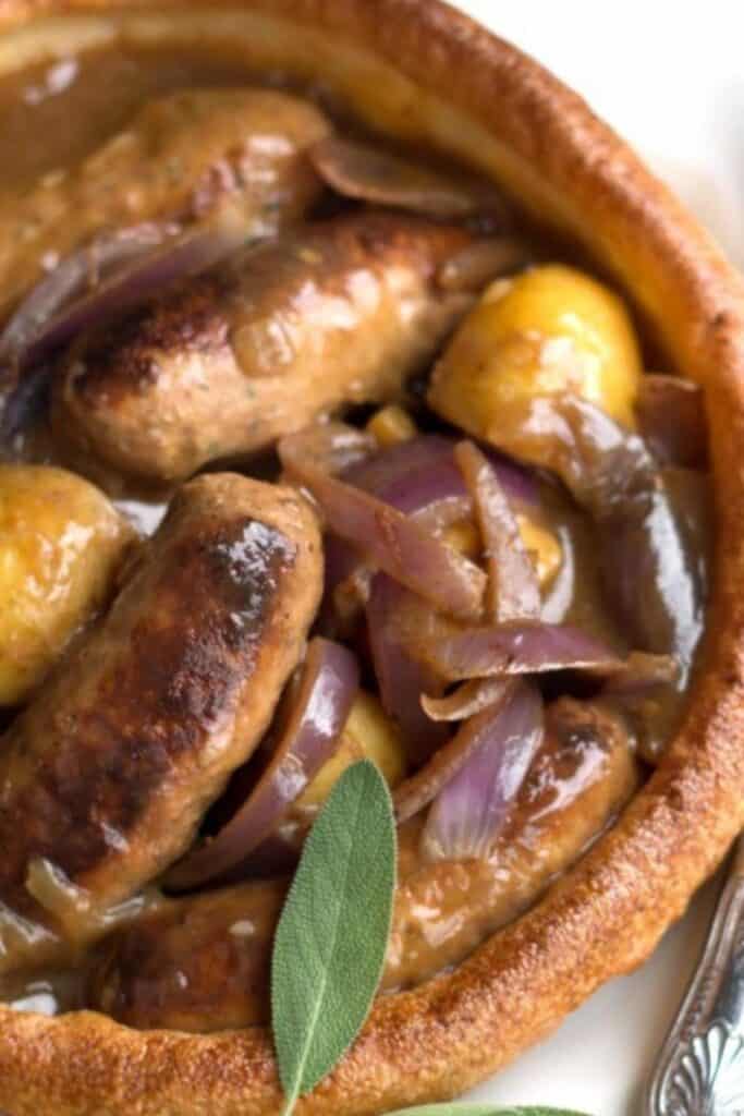 slow cooker apple sausage in onion gravy served in a Yorkshire pudding