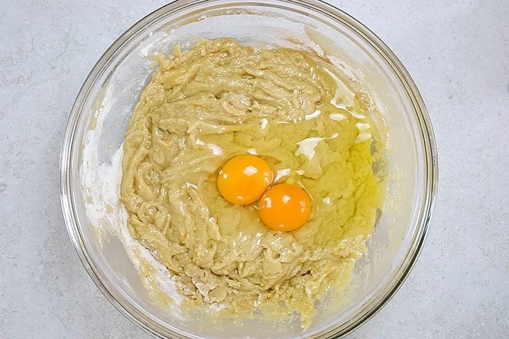 Two eggs added to the bowl with the batter