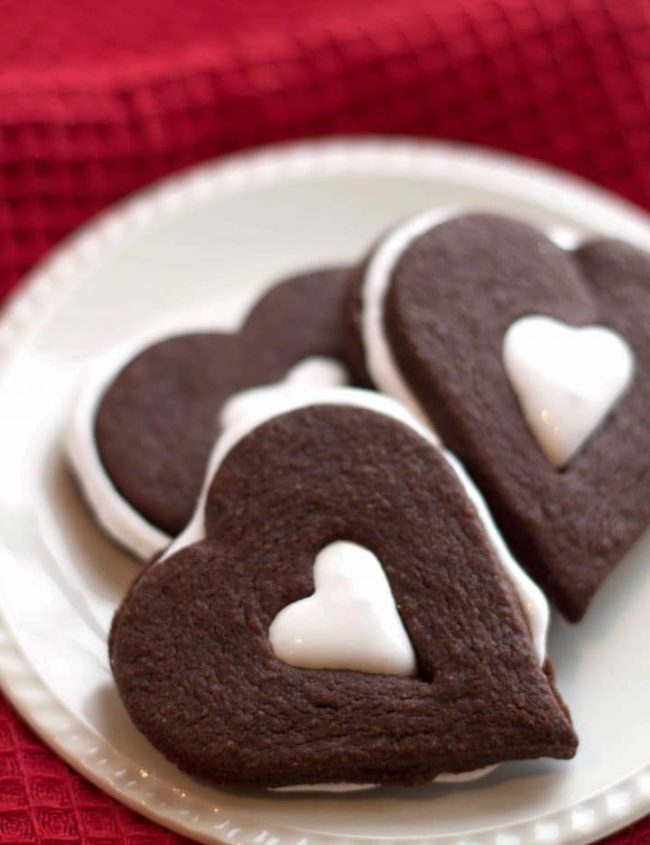 Three heart shaped Chocolate Marshmallow Sandwich Cookies on a plate