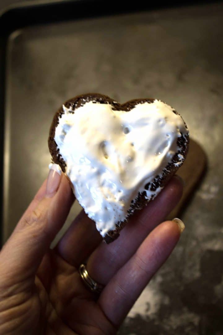 A Chocolate cookie with marshmallow spread over it