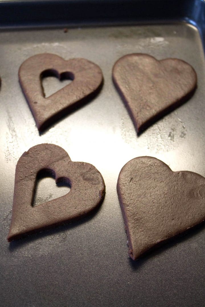 heart shaped Chocolate cookie dough on a pan ready to be baked