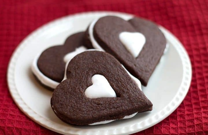 Three heart shaped Chocolate Marshmallow Sandwich Cookies on a plate