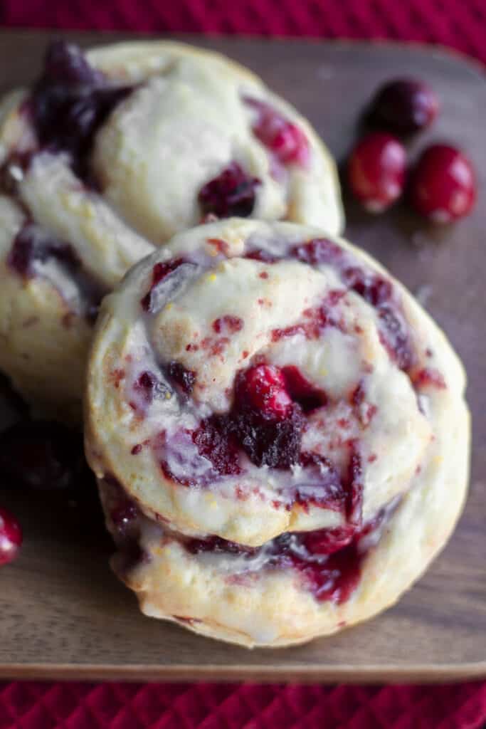 two swirled cranberry scones on a cutting board