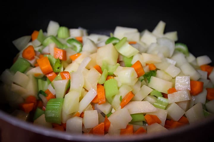 Onions, carrots, and celery cooking in a pan