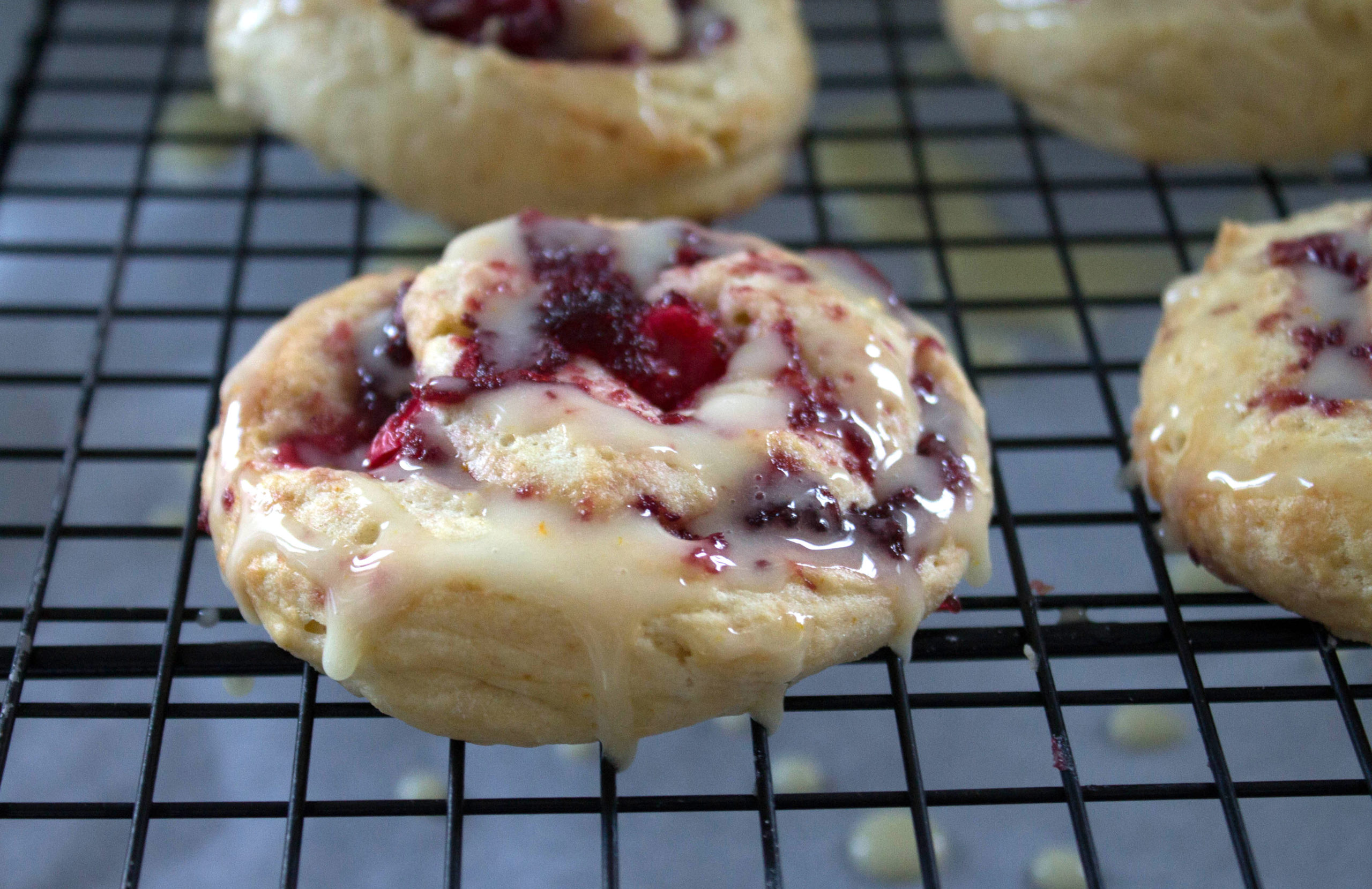 Iced Cranberry & Orange Swirl Scones on a cooling rack