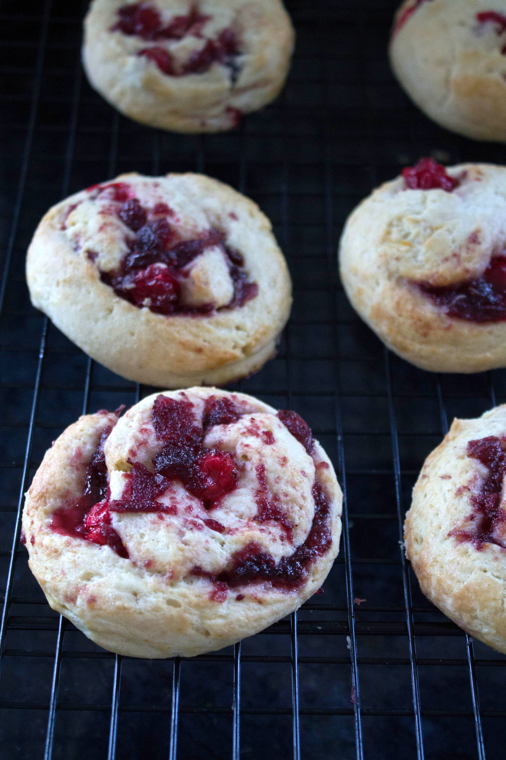 orange and cranberry swirl scones cooling on a wire rack