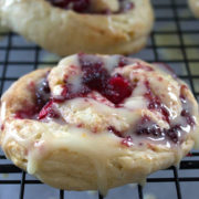 iced cranberry and orange swirl scones on a cooling rack