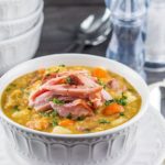 A bowl of vibrant, Split Pea and Ham Soup topped with shredded ham