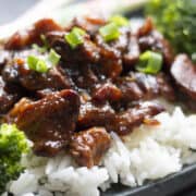 Slow Cooker Honey Soy Chicken on a bed of white rice with chopsticks