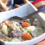 A bowl of Irish stew with a spoon