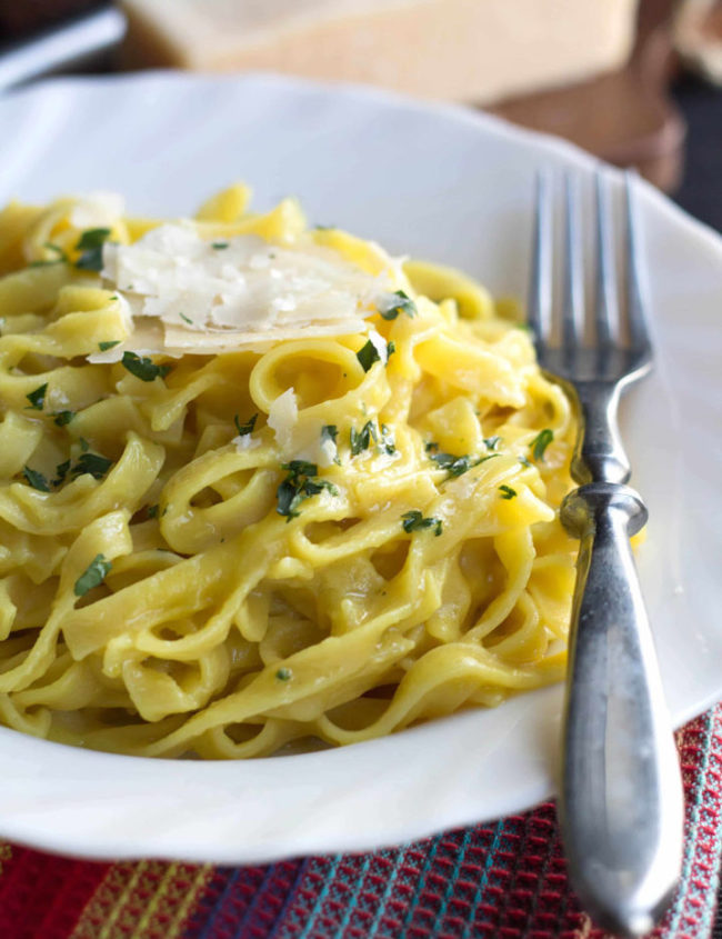 A dish of pasta with Saffron Cream Sauce topped with Parmesan Cheese