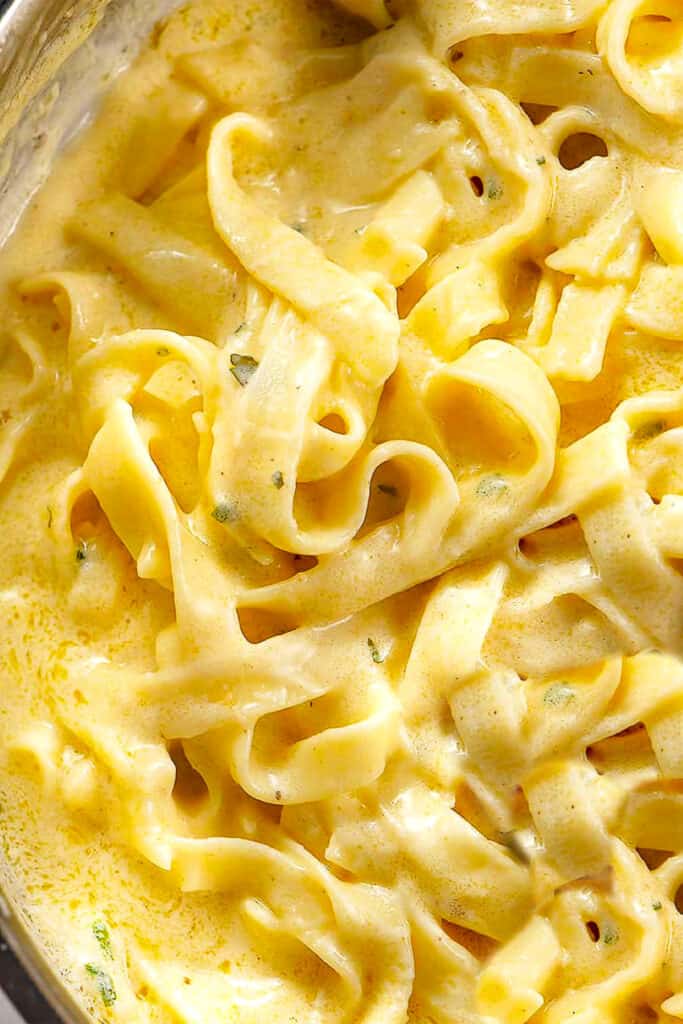 a close up Tagliarini pasta with Saffron Cream Sauce in a pan