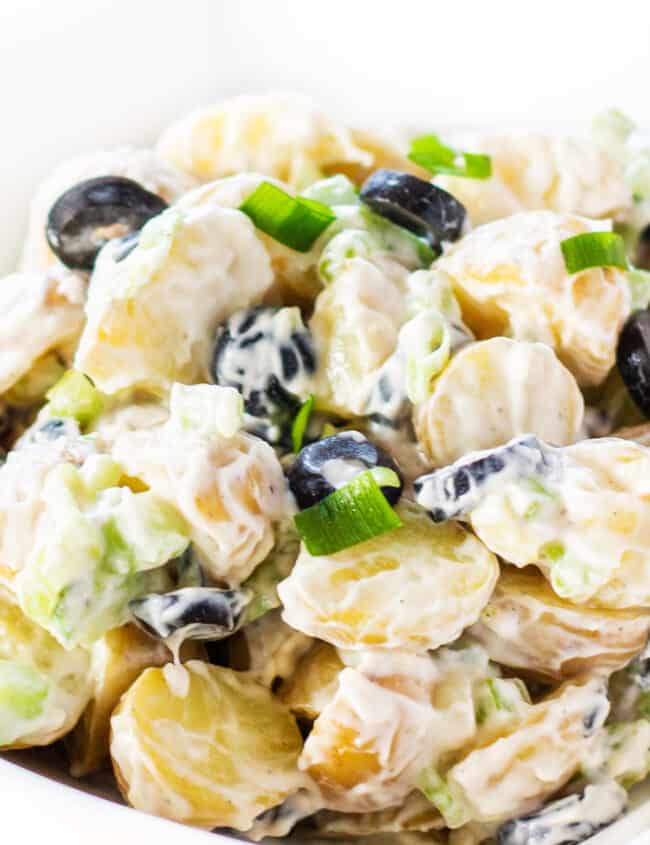 potato salad with olives and green onions ready to eat