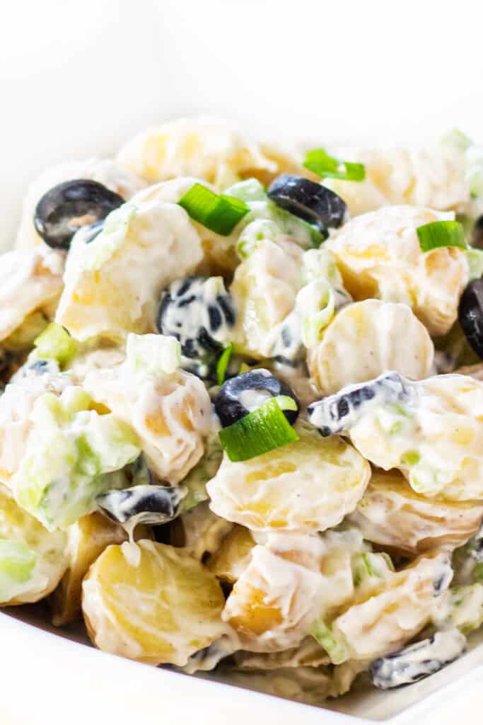 potato salad with olives and green onions ready to eat