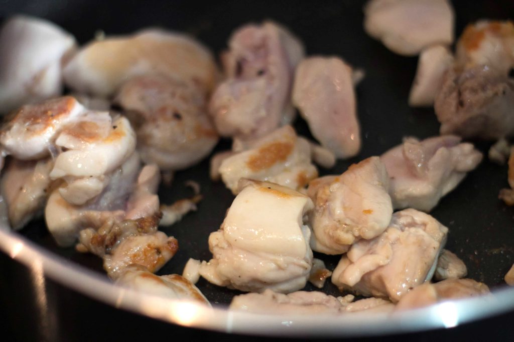 chicken in a pan being browned