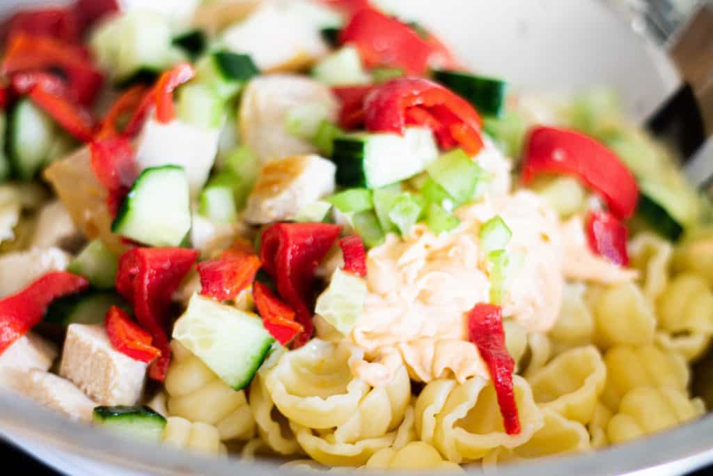 all of the ingredients added to a bowl ready to toss together