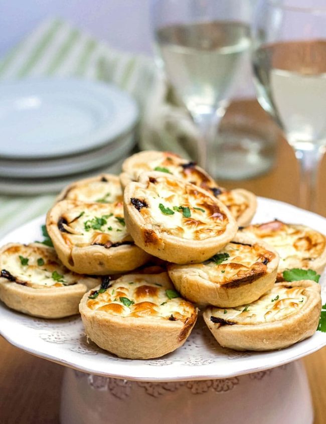 A serving dish piled high with Feta and Caramelized Onion Tarts