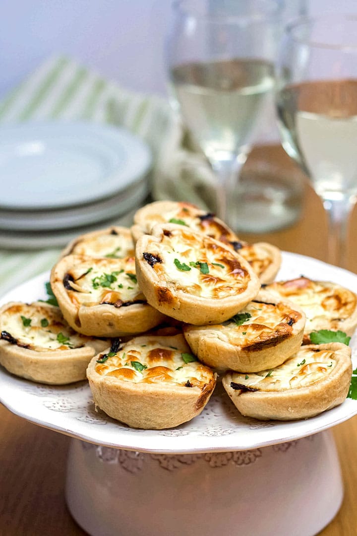 A serving dish piled high with Feta and Caramelized Onion Tarts