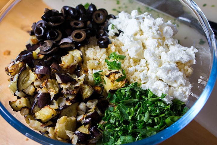 roasted vegetable mixture, chopped herbs and feta cheese added to the couscous in the bowl