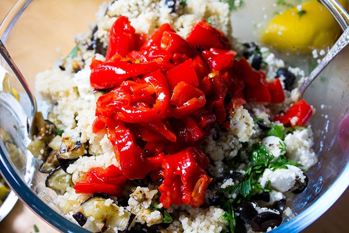 the red roasted peppers added to the bowl with the couscous